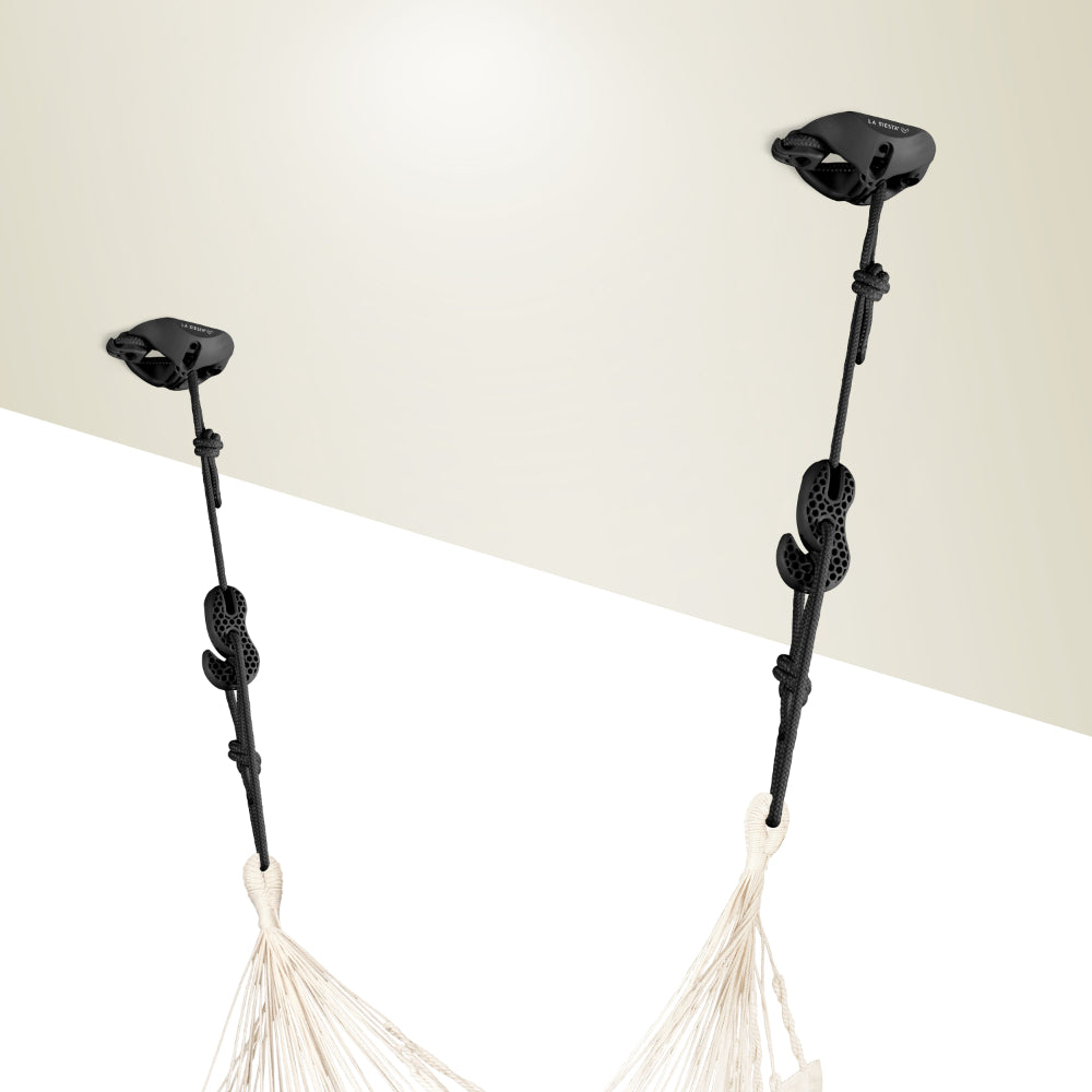 Black ceiling hooks with white hammock on a beige background