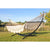 Black curved metal hammock stand and large white bar hammock