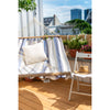 Fabric bar hammock hung outdoors on deck