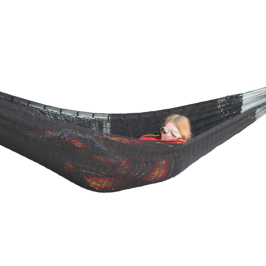 Woman relaxing in hammock between posts on a deck