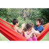 Children playing in large red and orange hammock