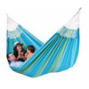 Family relaxing in large blue hammock