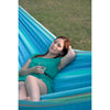 Women relaxing with glass of wine on large blue hammock
