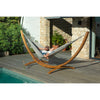 Hammock by pool on wooden hammock stand