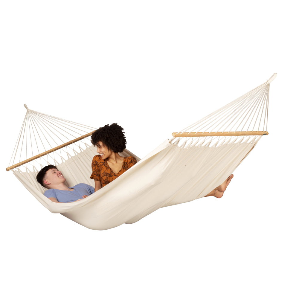 Two people relaxing together in large white bar hammock
