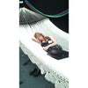 Woman resting on large woven Mexican hammock